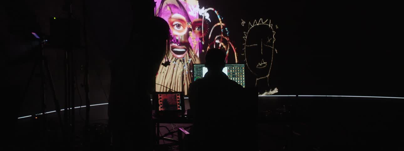 Two people reviewing images in a photo studio