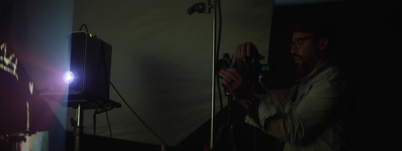 A man taking photos of a woman in a studio