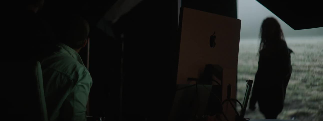 A man taking photos of a woman in a studio