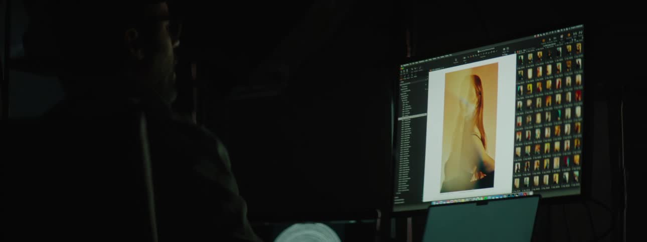 A photographer reviewing images on his computer in a studio