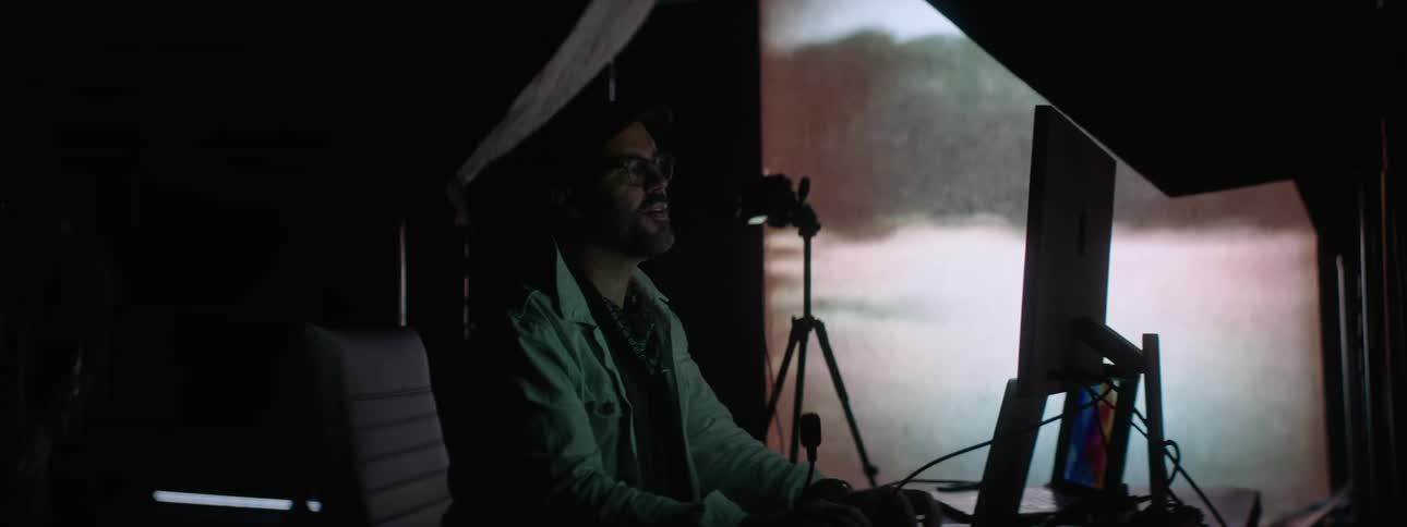 A man is editing film on his computer