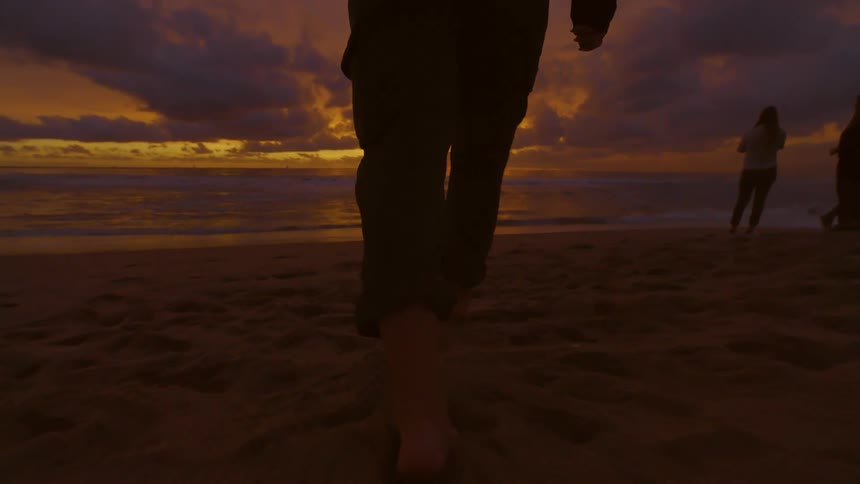 A clip of people walking around the beach