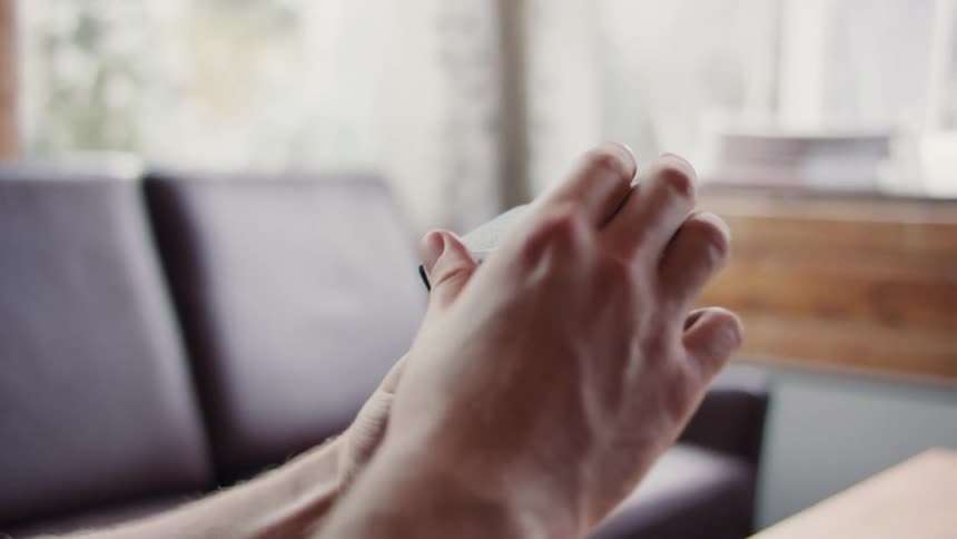 Closeup of a mans hands opening a vintage camera
