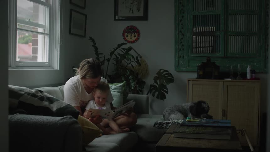 A clip of a mother baby sitting her kid in the living room