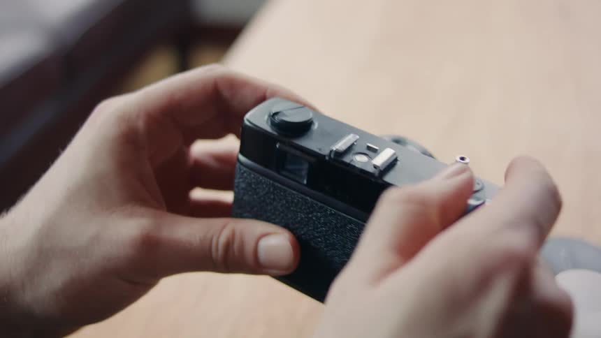 A clip of a person holding a film camera