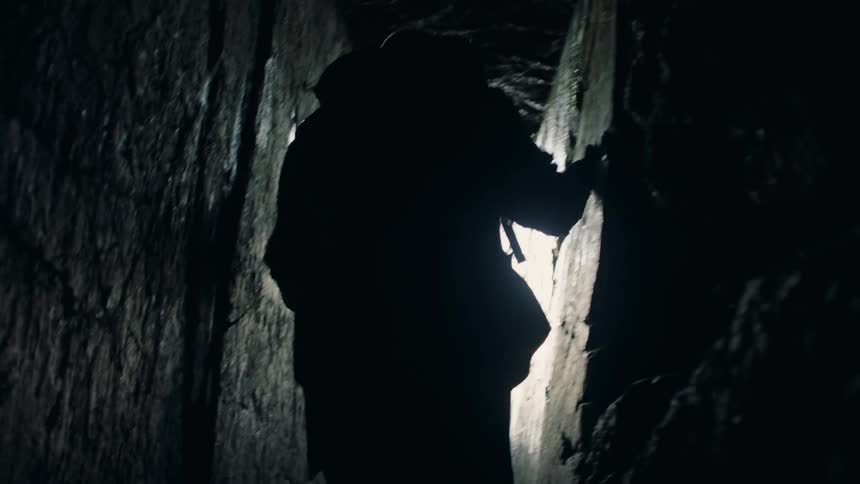 Man walking inside a frozen tavern through a dark and short corridor and exiting