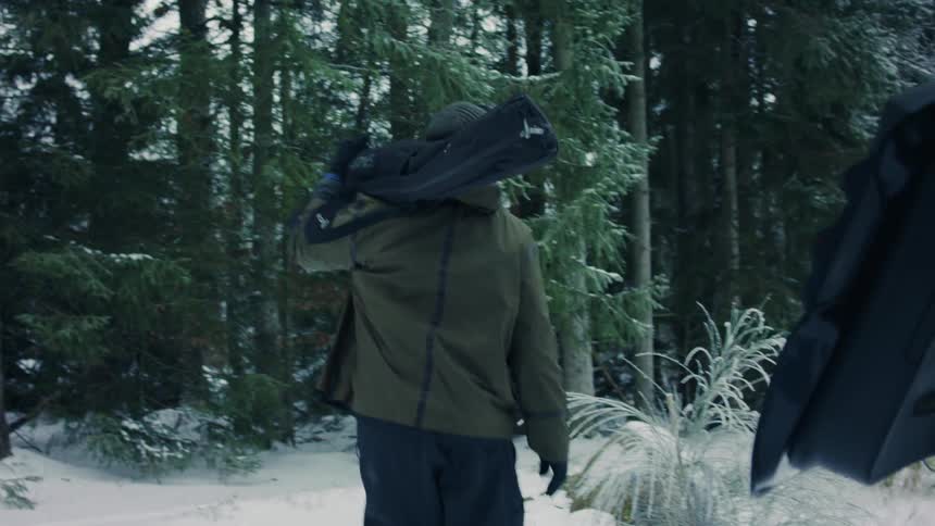 A woman taking skis out the back of an suv