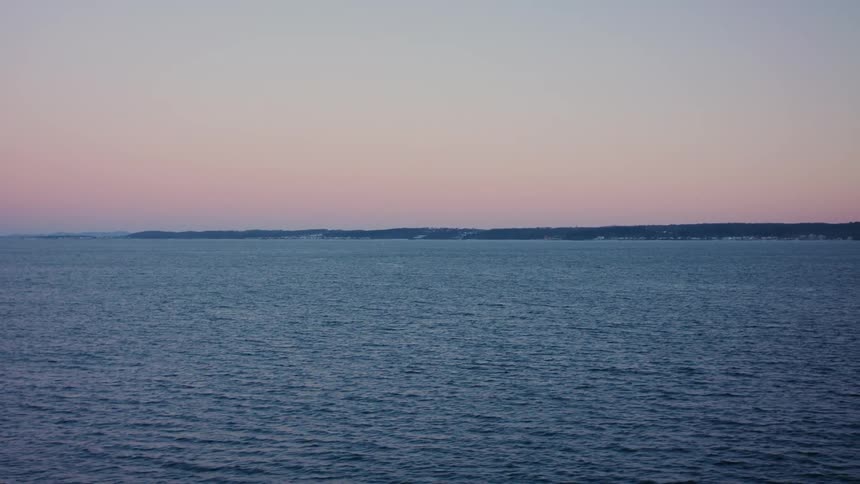 View of the moving sea on a day with a purple dawn sky