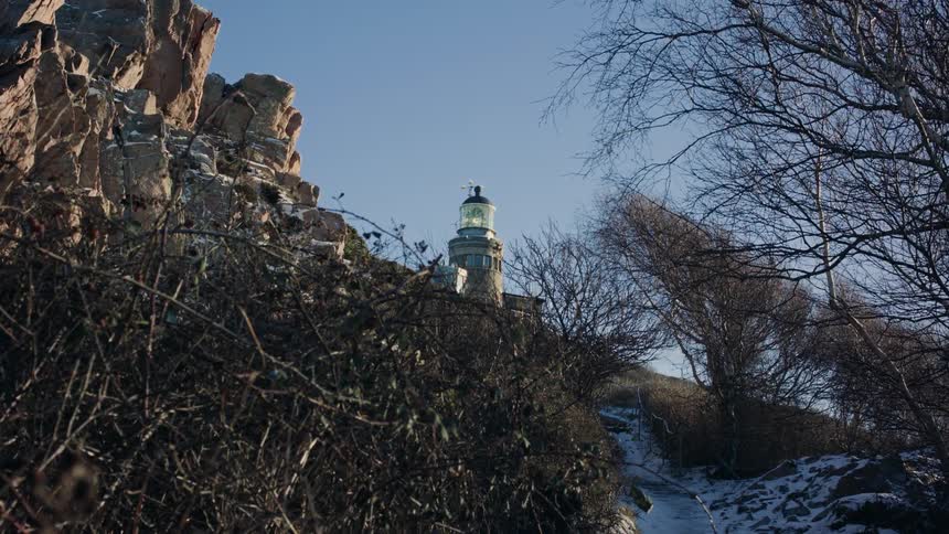 A view of a lighthouse outdoors on a snowy day
