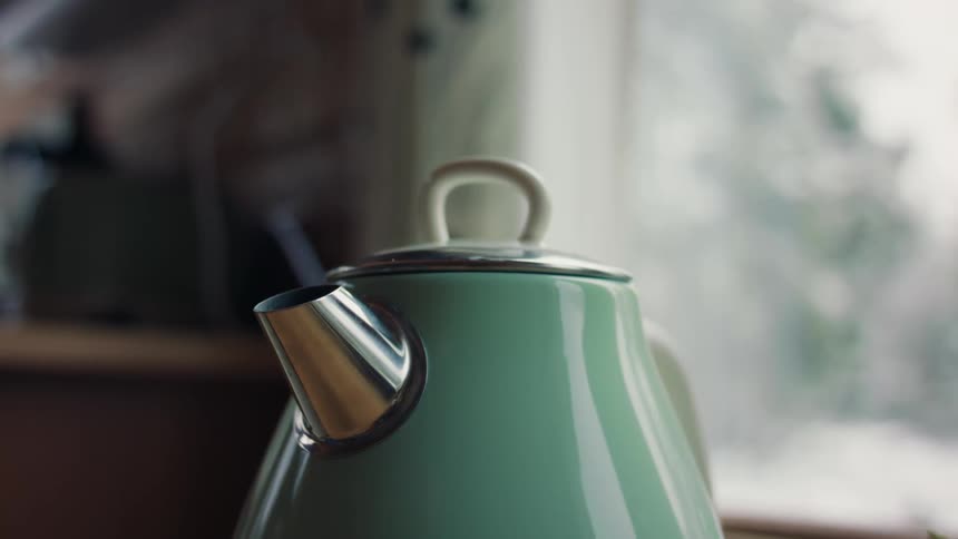 A kettle heating up until it releases steam