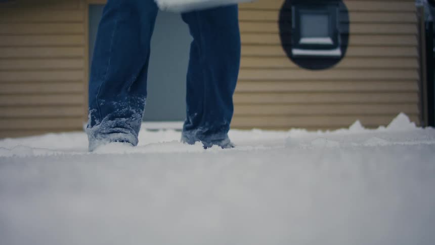 A clip of a person shoving away the snowy path