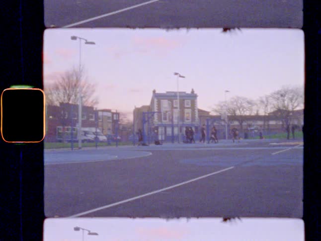 People playing basketball at an outdoor court