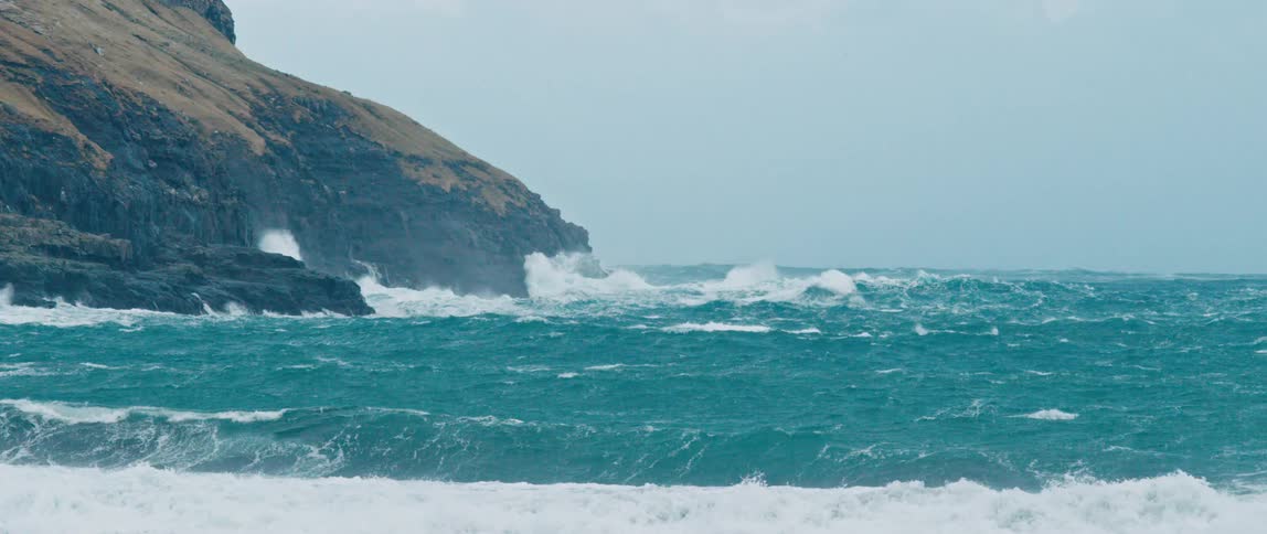 Sea waves break on the beach during the day