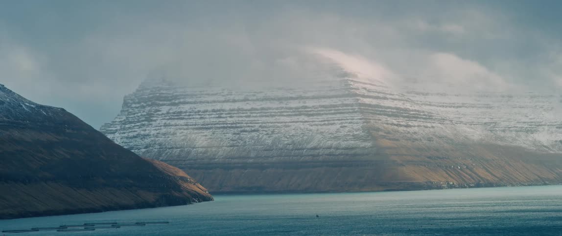 Landscape of snow capped mountains near the sea