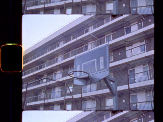 Basketball hoop with an apartment block in the background