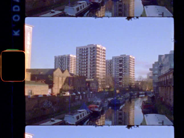 Tower blocks in the sun next to a canal