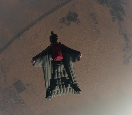 A man that is skydiving outdoors on a sunny day
