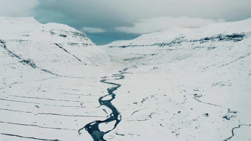 Aerial view of river in a snow covered valley