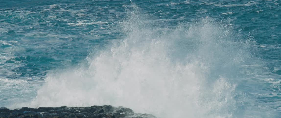 Waves from the sea splashing on the rocks by the shore