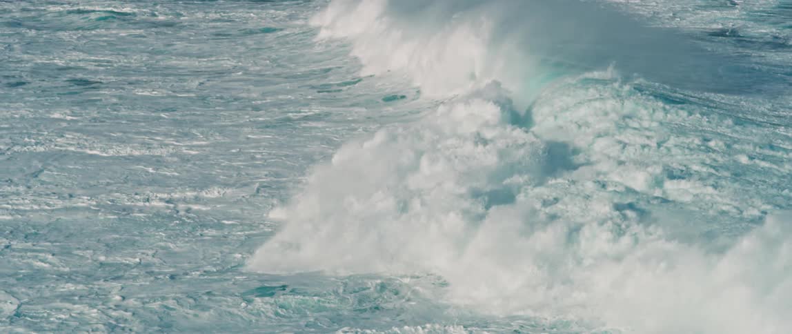 A rough sea with waves crashing on the shore