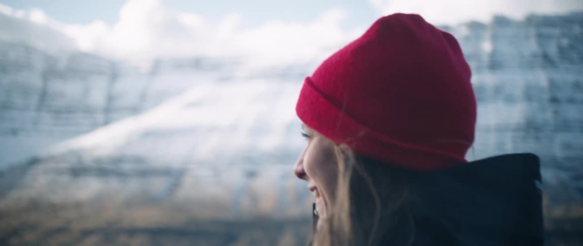 Woman smiles and look at the snowy landscape