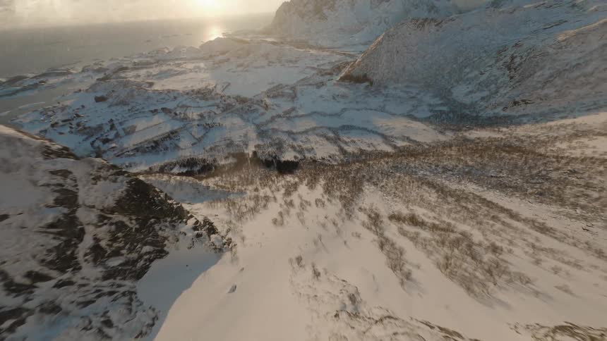 Flying over a snow covered valley