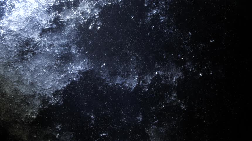 View of the ocean at night in slow motion with frozen segments