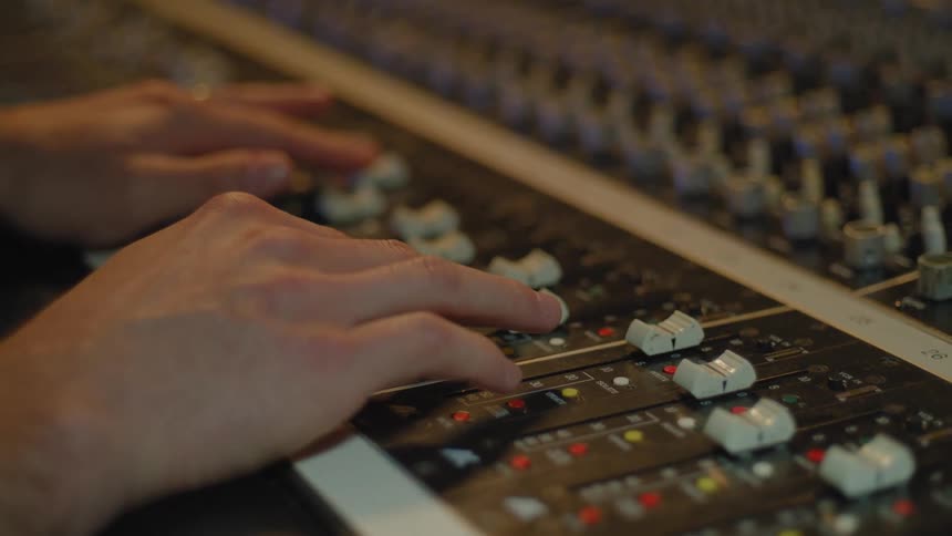 A person is operating a large control panel