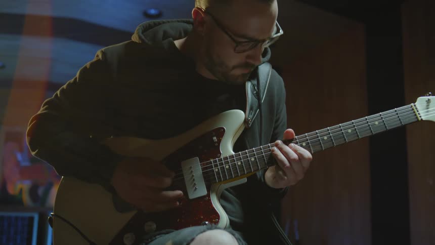 A man is playing the guitar