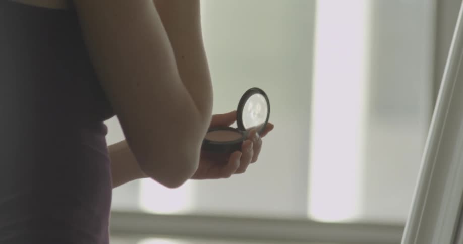 A woman applies makeup