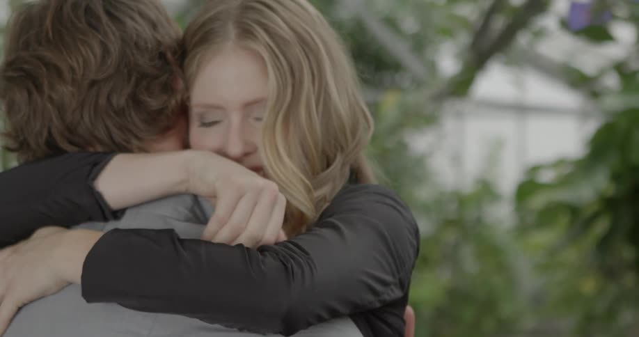 Woman smiles hugging a man