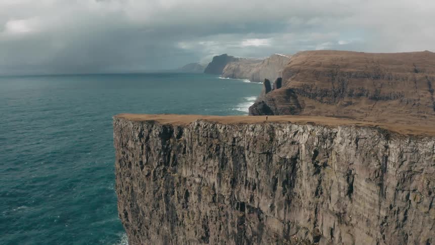 An aerial clip of a mountain by the sea shore