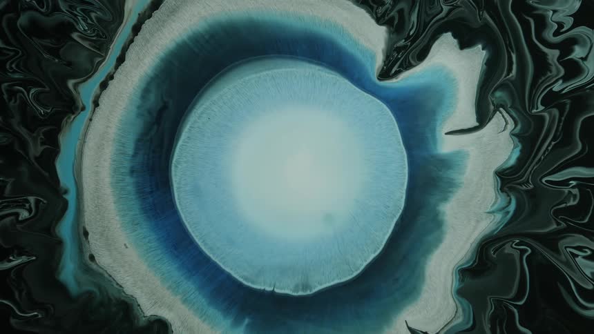 An exploding expanding circle of paint in a swirl of color