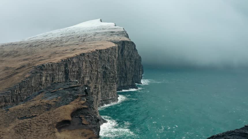 An aerial view of cliffs on the edge of the ocean