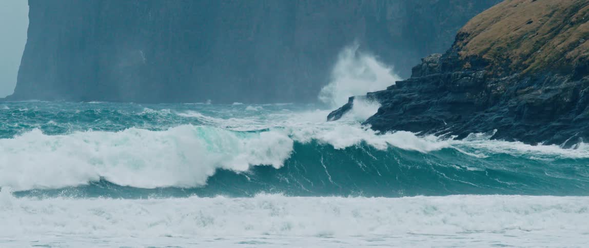 Large waves are crashing on the mountains