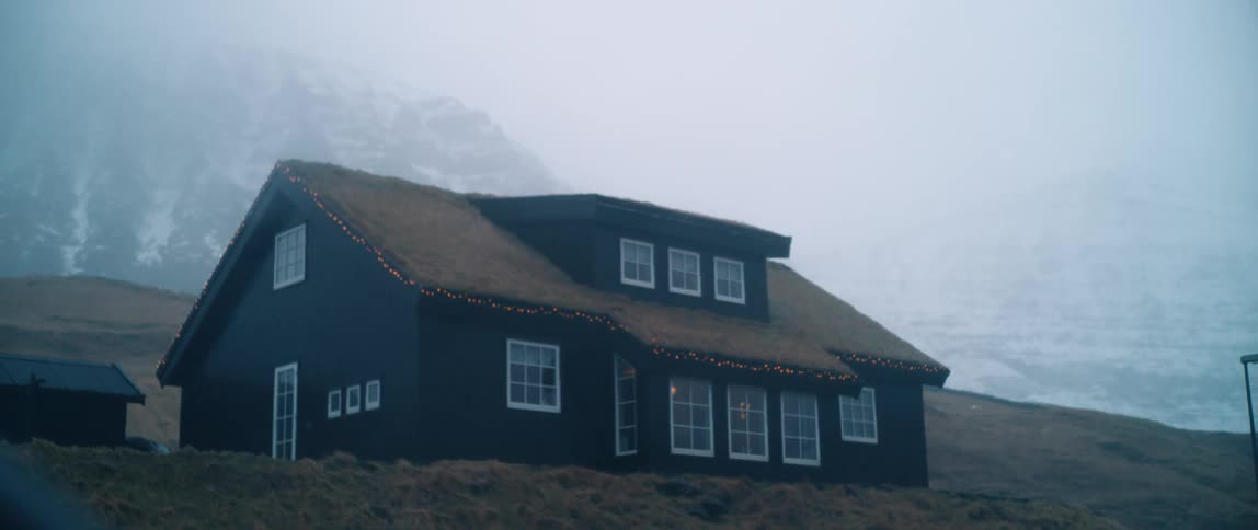 A cabin on top of a hill at dusk