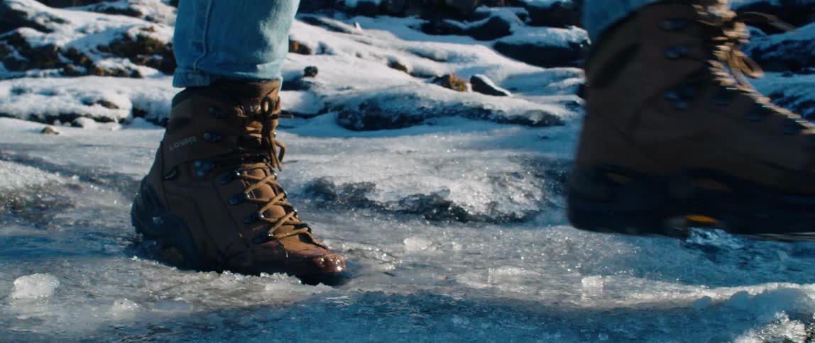 A person walks through the icy water