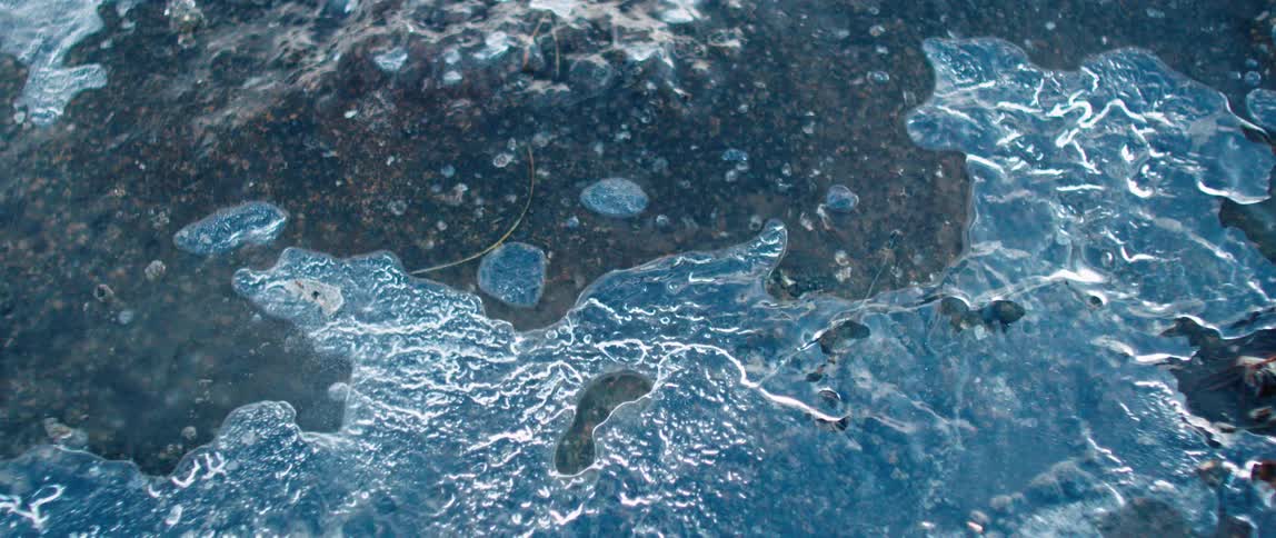 A view of some water flowing over rocks outdoors