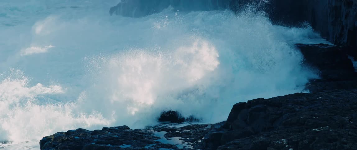 Heavy waves crash against the shore