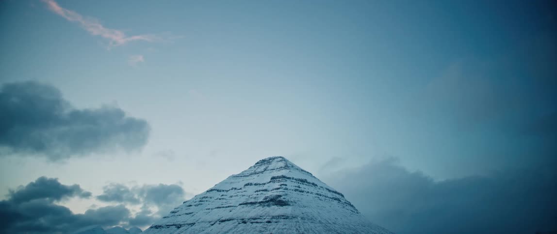 A mountain top completely covered in ice and snow