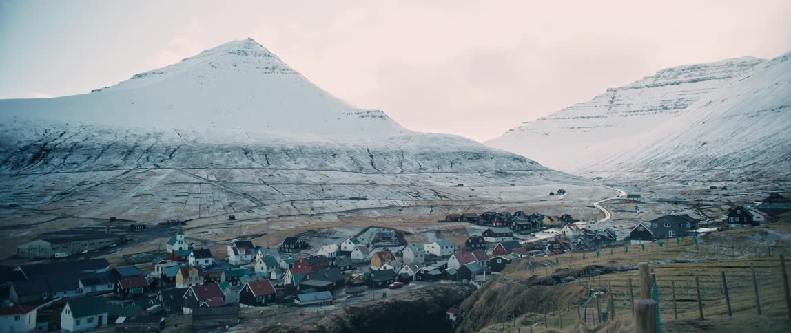 A small town in a region with snowcapped mountains