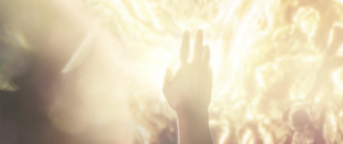 A hand reaching towards an abstract ball of light