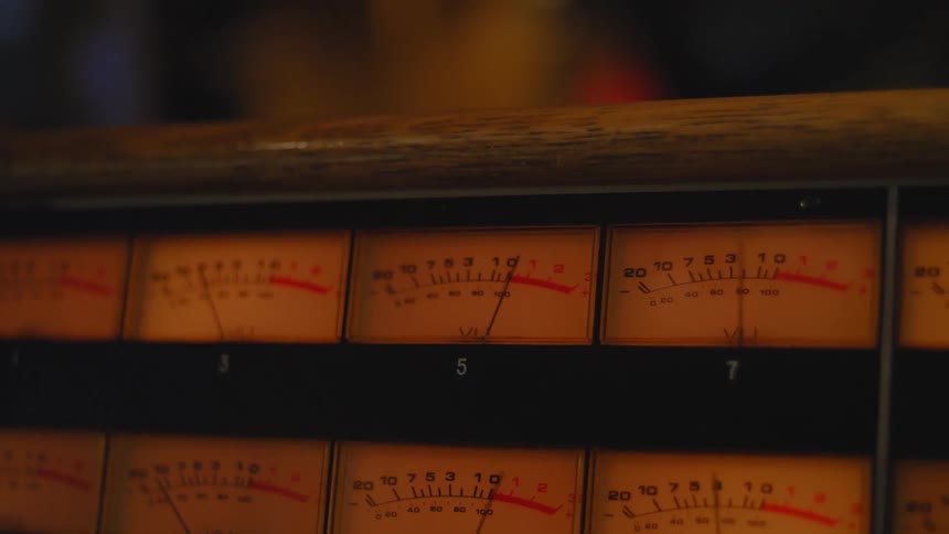 Closeup of a mechanical device with moving noise meters