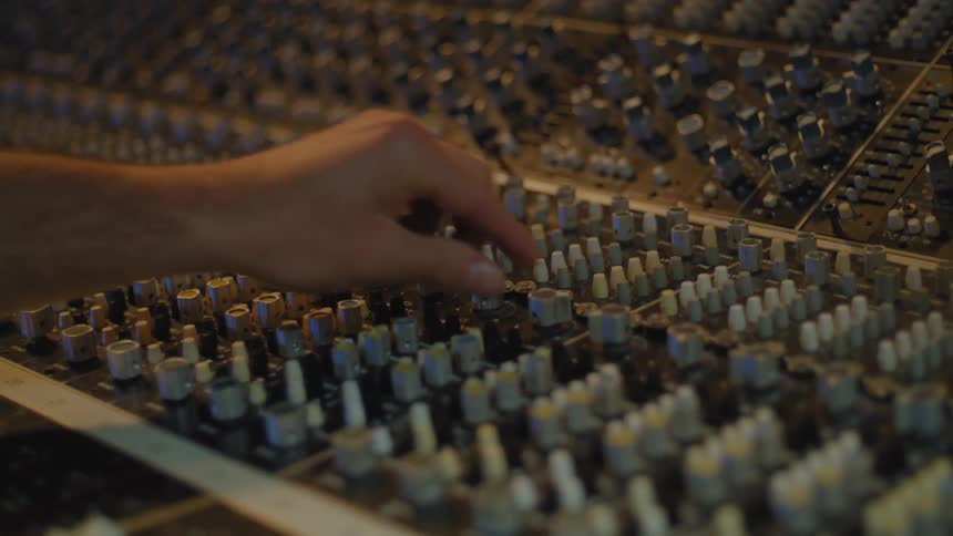 A person is operating a soundboard