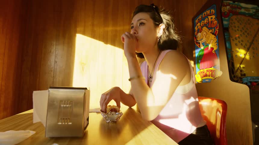 A woman is eating in the restaurant