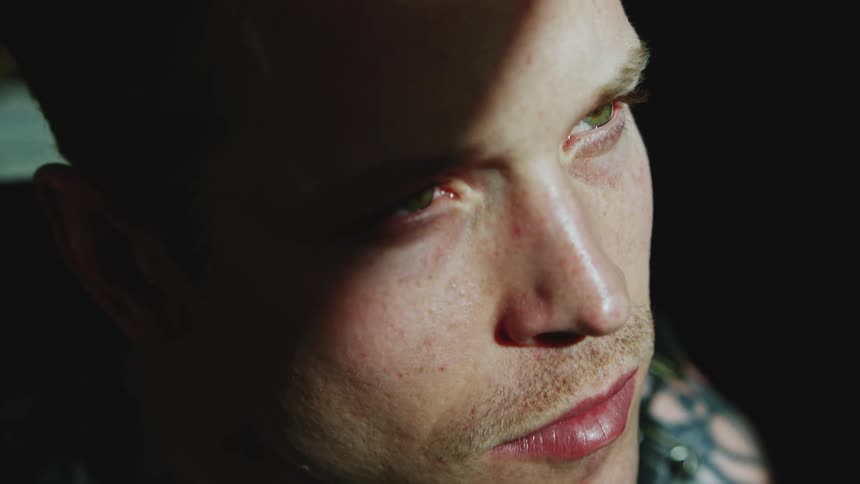 Caucasian man looks towards the light