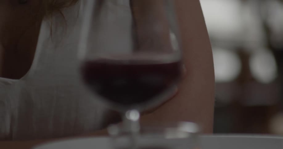 A woman is crossing her arms at a restaurant