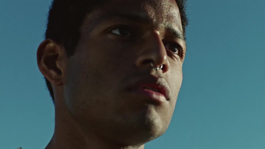 Close up of a young black man with a serious expression