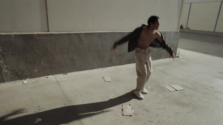 Boy dancing in an industrial area
