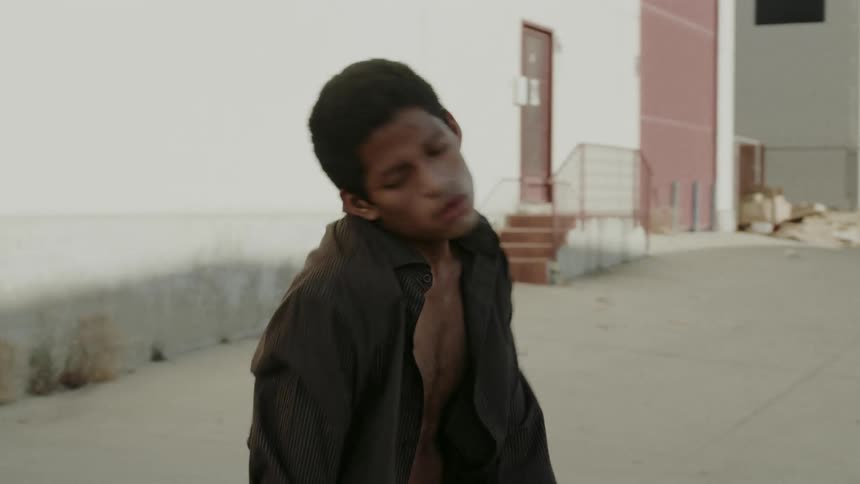A young dancer dancing in the streets of a neighborhood